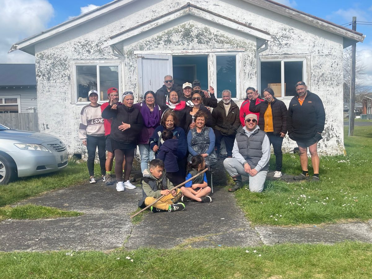 Whānau gathered outside the whare at the Paheke hui, September 2024