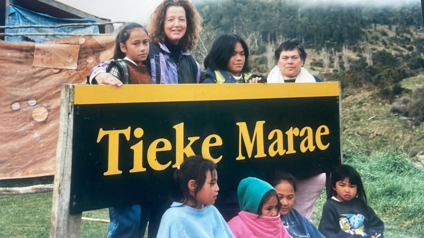 Whānau and tamariki at the Tieke Marae sign